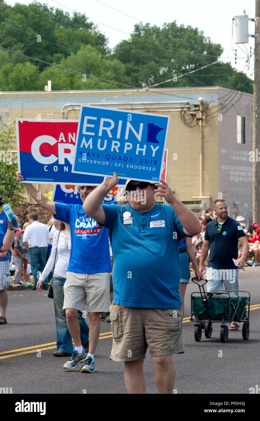 Mendota, MN/USA – JULY 14, 2018: Supporters of candidates Erin Murphy and Angie Craig march in annual Mendota Days Parade holding campaign signs. Stock Photo