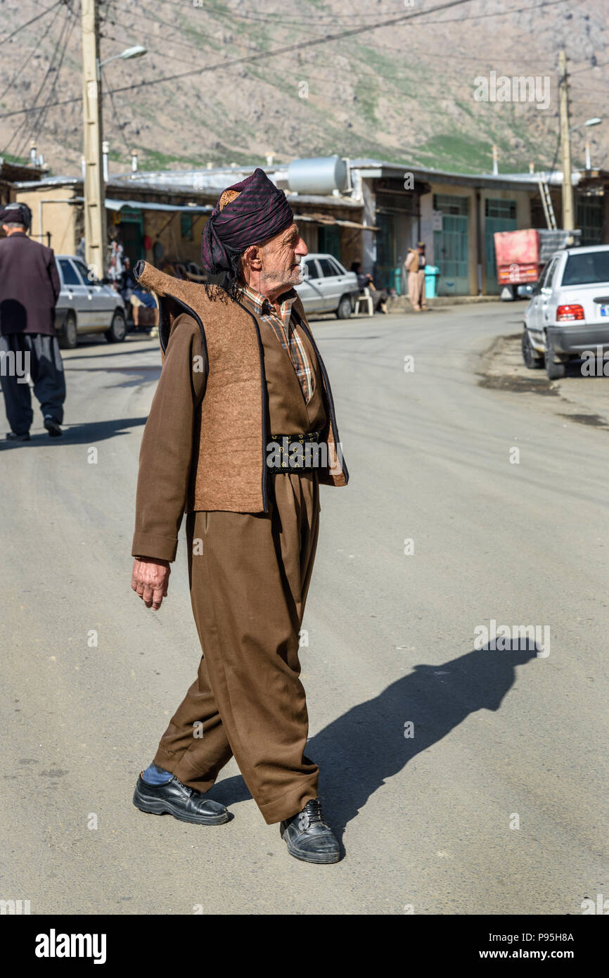 Howraman, Kurdistan Province, Iran - April 5, 2018: Kurdish man in traditional clothing on the street of Howraman village or Uraman Takht in Zagros Mo Stock Photo