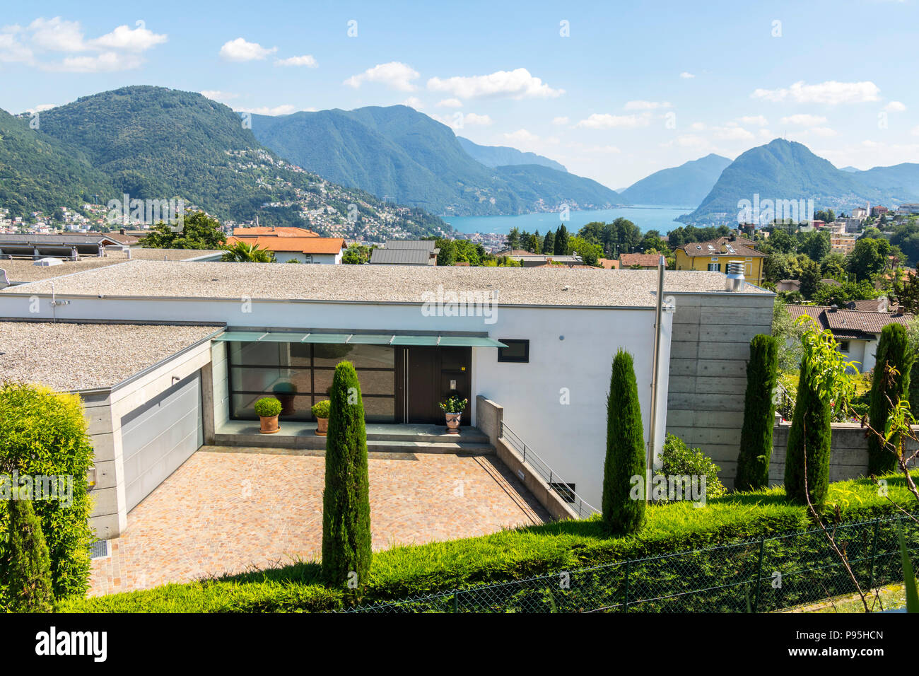 Modern Luxury family home contemporary architecture, overlooking Lake  Lugano mountain town village Lugano Switzerland rich luxurious best life  living Stock Photo - Alamy