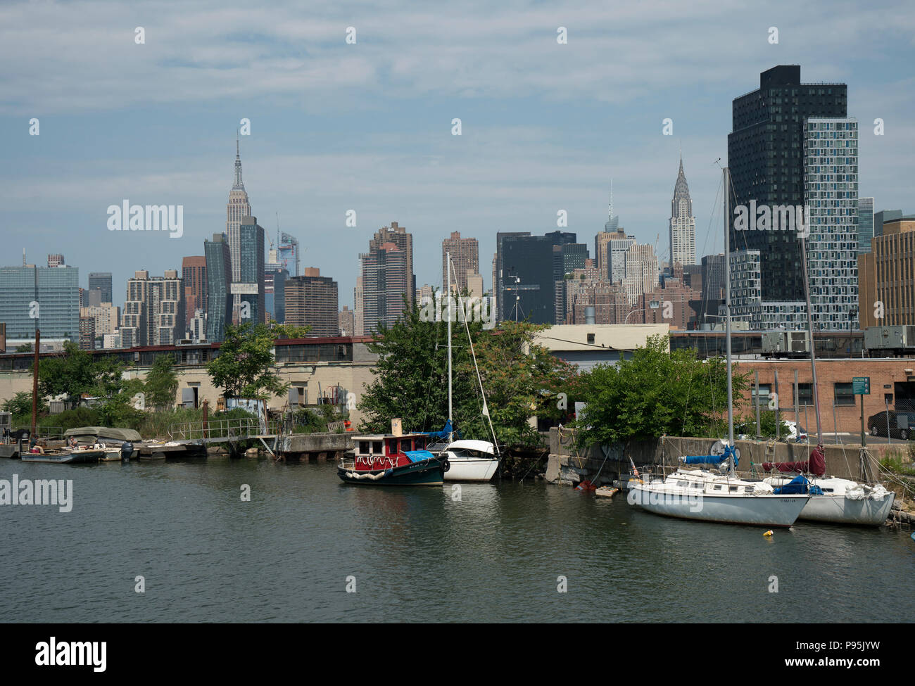 The skyline of Manhattan’s east side as seen from Newtown Creek, an estuary of Long Island Sound that runs between Brooklyn and Queens. Stock Photo