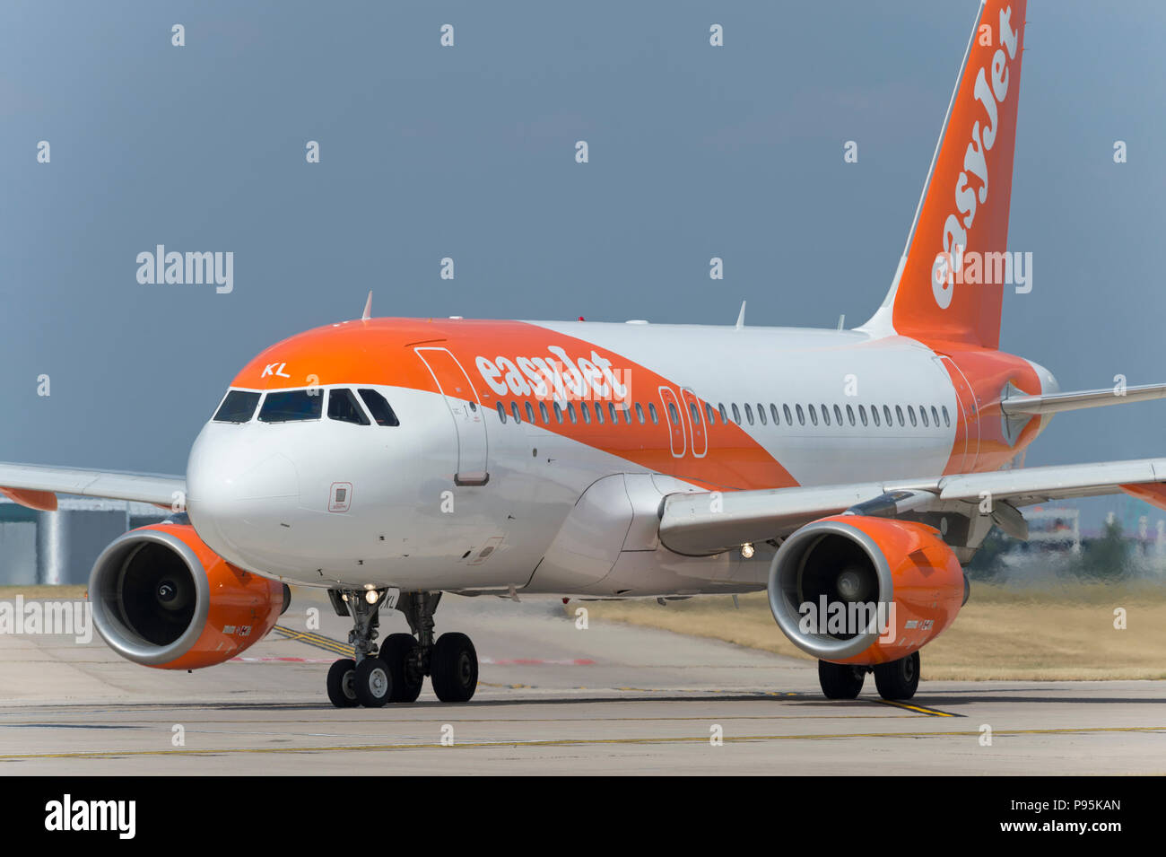 An Easyjet Airbus A319 taxis along the runway at Manchester Airport whilst preparing to take off. Stock Photo