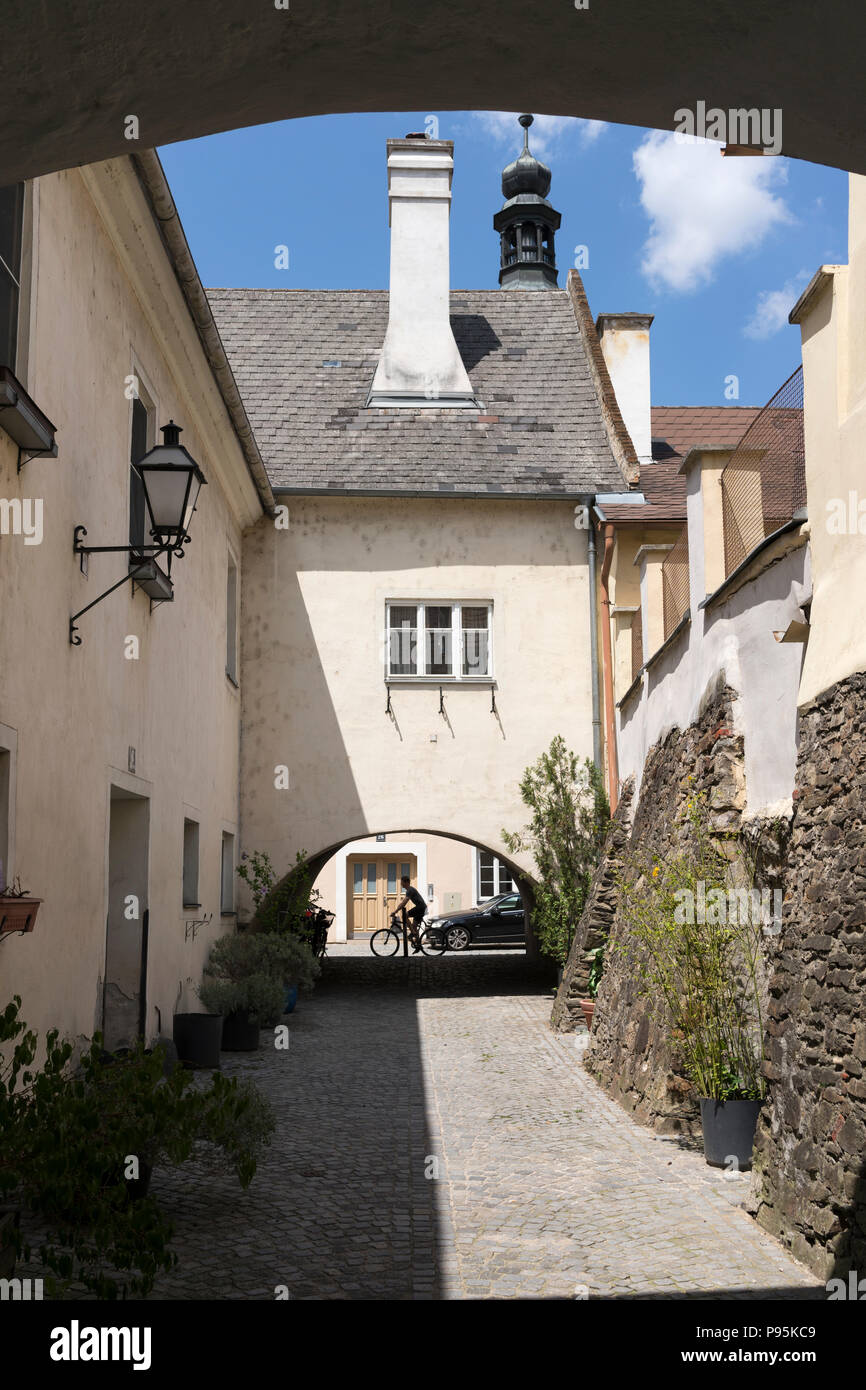 A narrow alleyway with a buttressed wall in the old town of Stein, a UNESCO World Heritage Site, Lower Austria Stock Photo