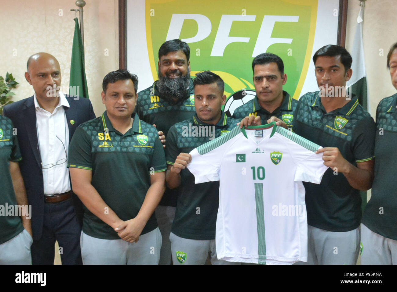 Lahore, Pakistan. 15th July, 2018. Pakistani officials, Brazilian head  coach Jose Antonio Nogueira, coach Shahid Anwar, Media Marketing manager  Shahid Khokhar and players of national football team unveiling the kits of  upcoming
