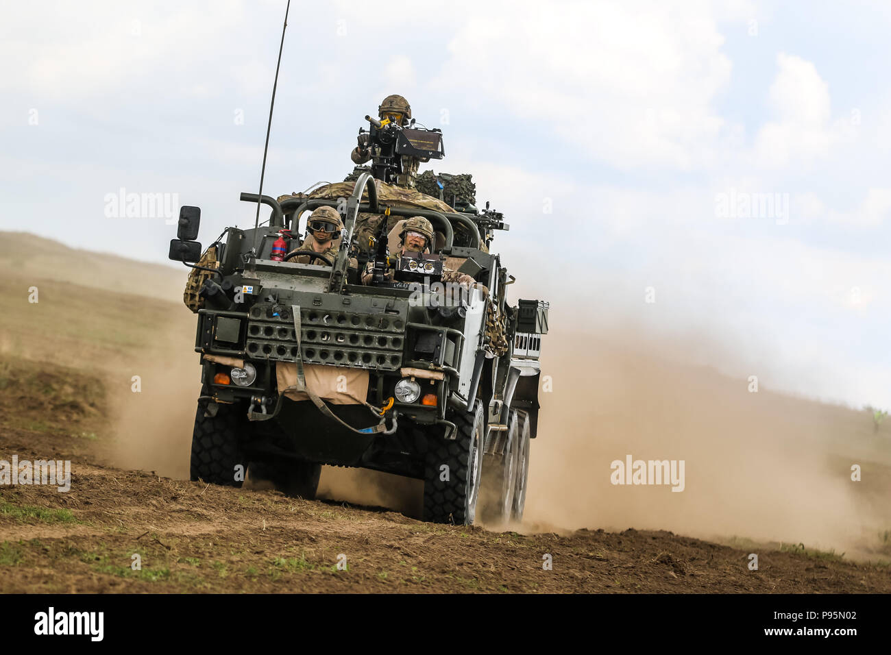 A Mobility Weapon-Mounted Installation Kit “Jackal” with the U.K. army 1st The Queen's Dragoon Guards moves to secure an area during the polish 15th Mechanized Brigade's Tank Day celebration with the Battle Group Poland at Orzysz, Poland on July 14, 2018. Battle Group Poland is a unique, multinational coalition of U.S., U.K., Croatian and Romanian Soldiers who serve with the Polish 15th Mechanized Brigade as a deterrence force in support of NATO’s Enhanced Forward Presence. (U.S. Army photo by Spc. Hubert D. Delany III /22nd Mobile Public Affairs Detachment) Stock Photo