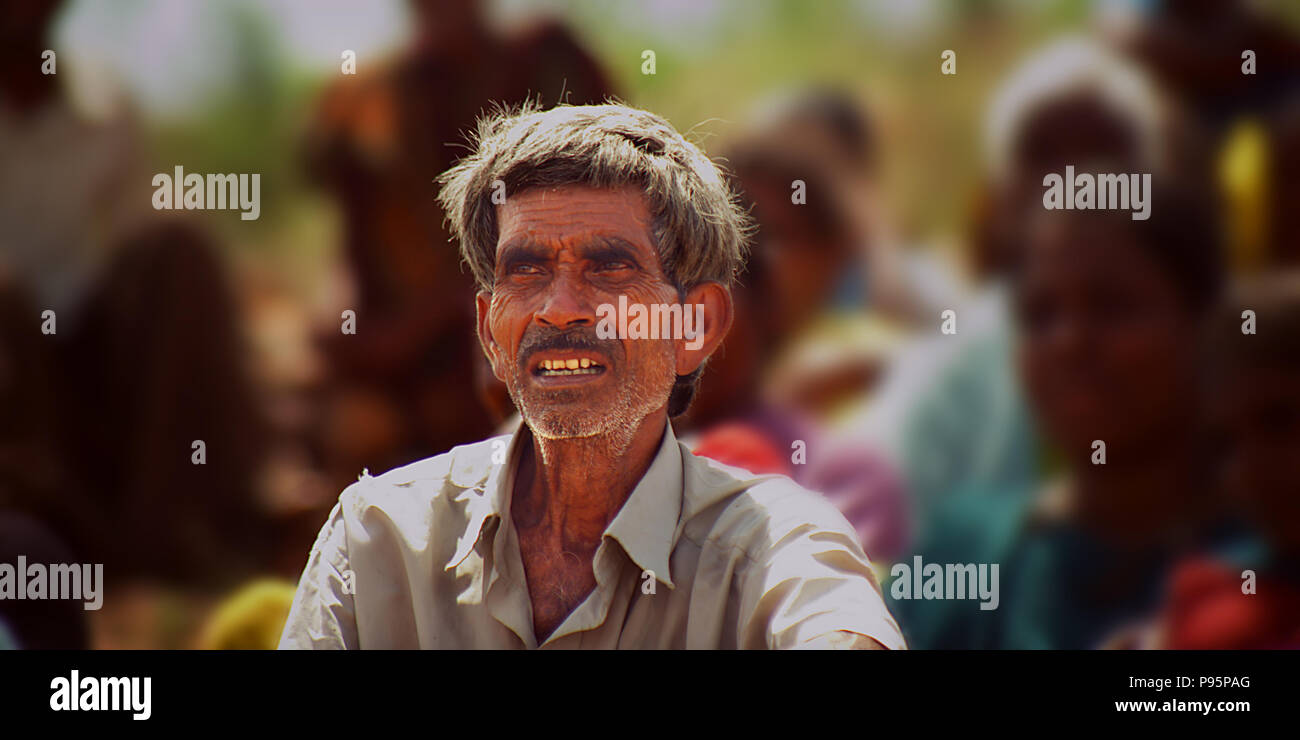 Portrait of a smiling farmer sitting on field, nature background Stock ...