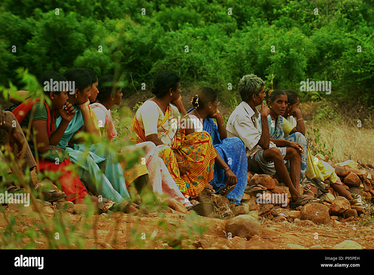 Indian farmer people sitting outside on paddy field, nature background Stock Photo