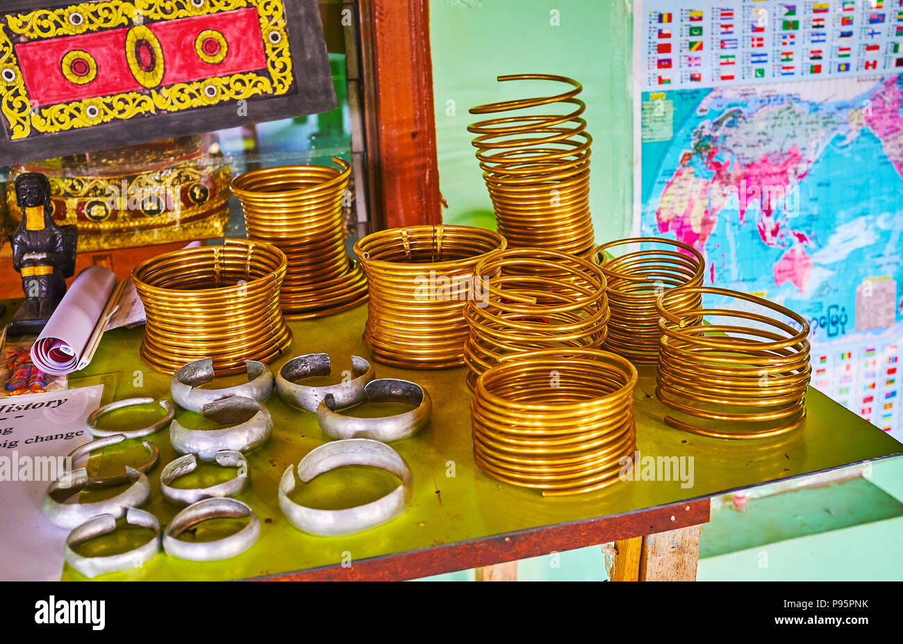INLE LAKE, MYANMAR - FEBRUARY 18, 2018:  The exhibition in authentic workshop with examples of brass neck rings of Padaung Kayan women, also famous as Stock Photo
