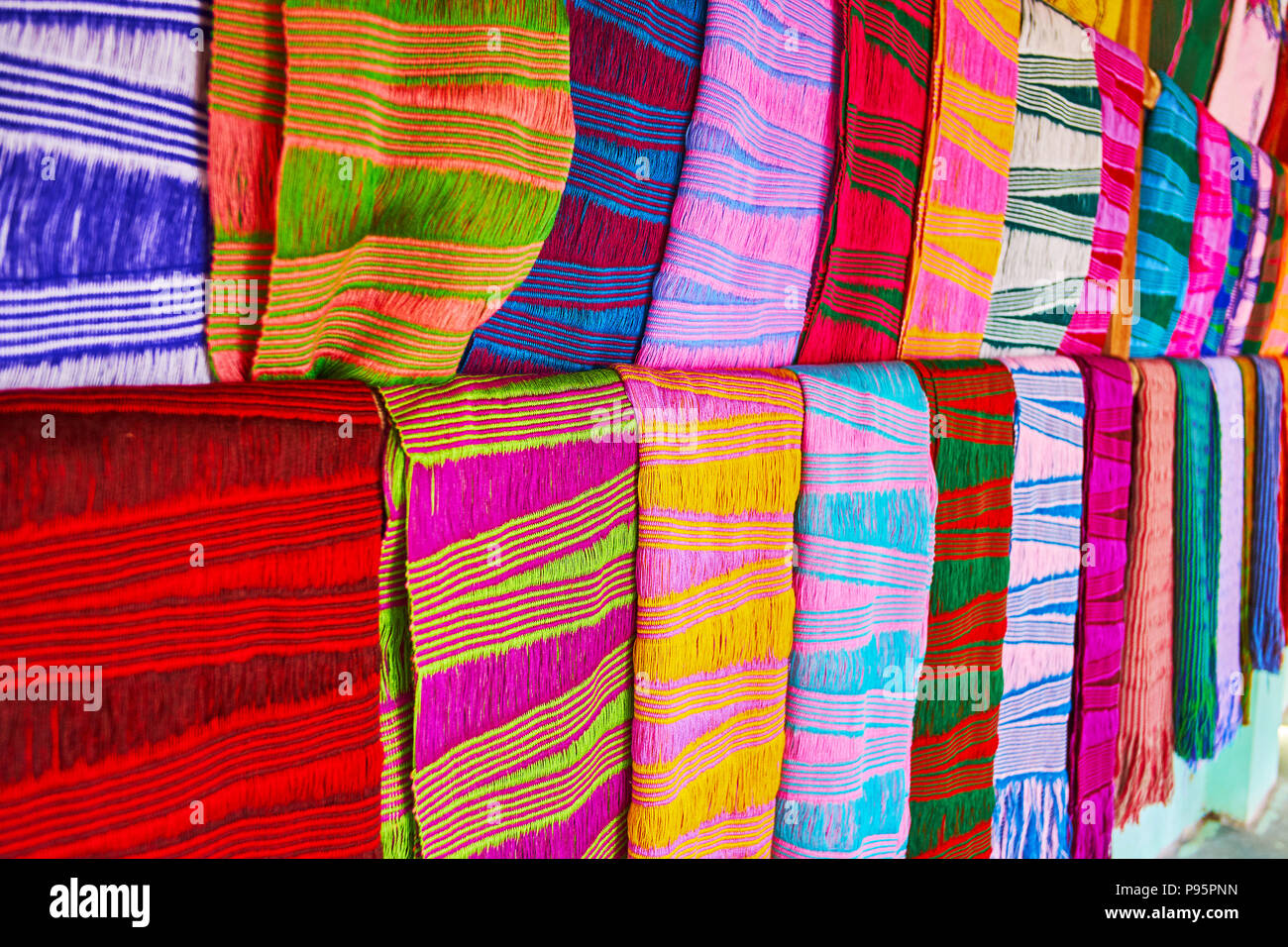 The close-up view of traditional scarfs, made in authentic workshop by Padaung Kayan women (long neck women), the bright colored peaces decorated with Stock Photo