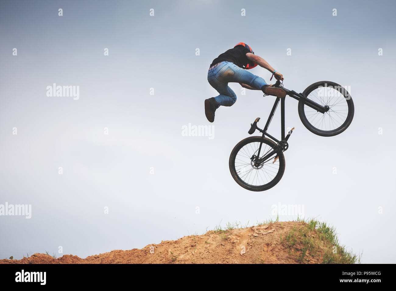 mtb dirt rider doing trick on a jump Stock Photo