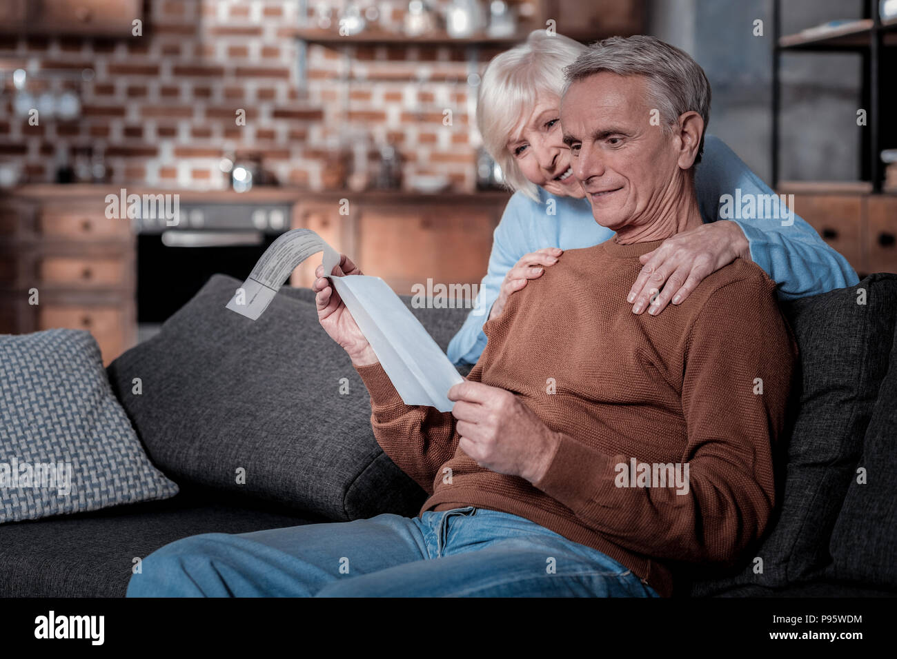 Pleased elderly people checking their pension Stock Photo