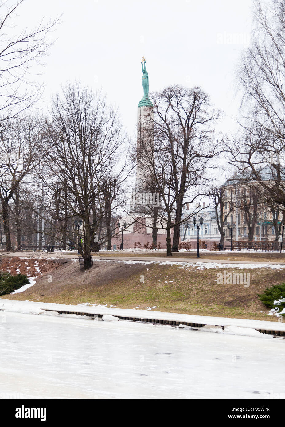 The view across Riga canal towards the Freedom Monument in Riga, Latva.  The memorial honours soldiers killed during the Latvian War of Independence. Stock Photo