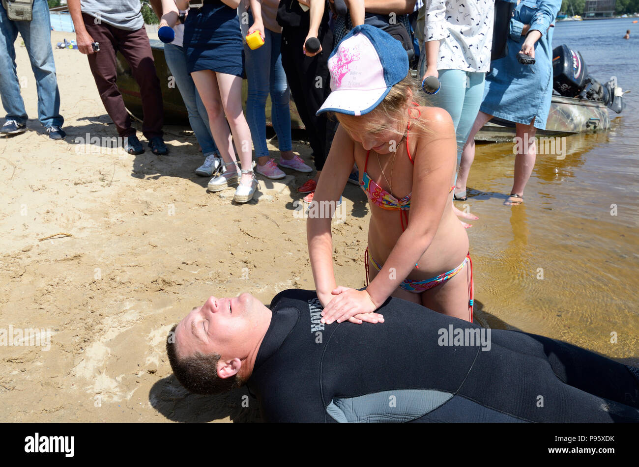 Lifeguards demonstrate right ways of artificial respiration for drowning. Stock Photo