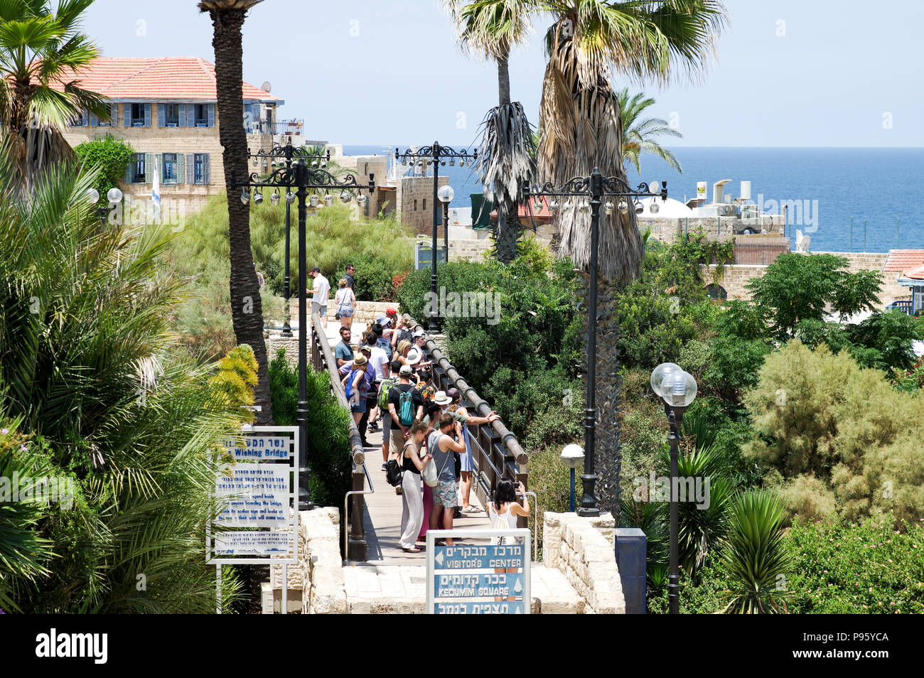 Group of tourists crossing the Wishing Bridge in Old Jaffa - Tel Aviv, Israel Stock Photo