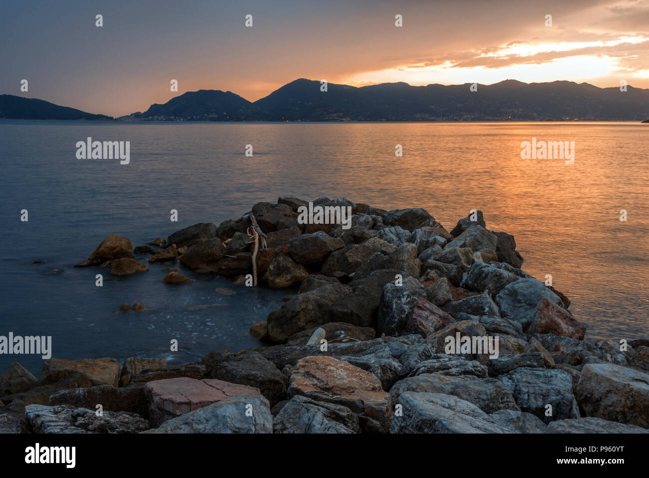 Time exposure of rocks and the ocean, from Tellaro looking towards La Spezia, Italy. Stock Photo