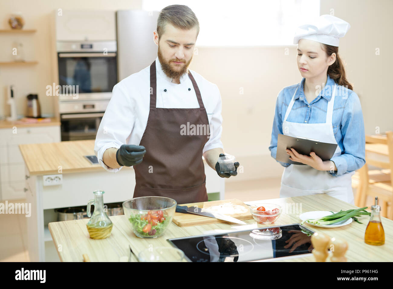 Young Professional Chef Working in Restaurant Stock Photo