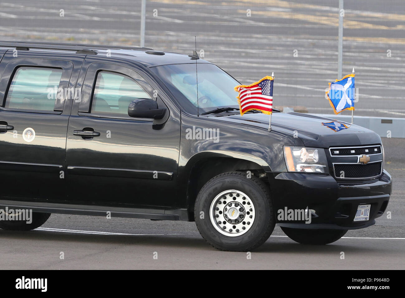 A US Presidential car flies the Saltire alongside the US flag as it waits  for the arrival of US President Donald Trump and his wife, Melania, at  Prestwick airport in Ayrshire, en