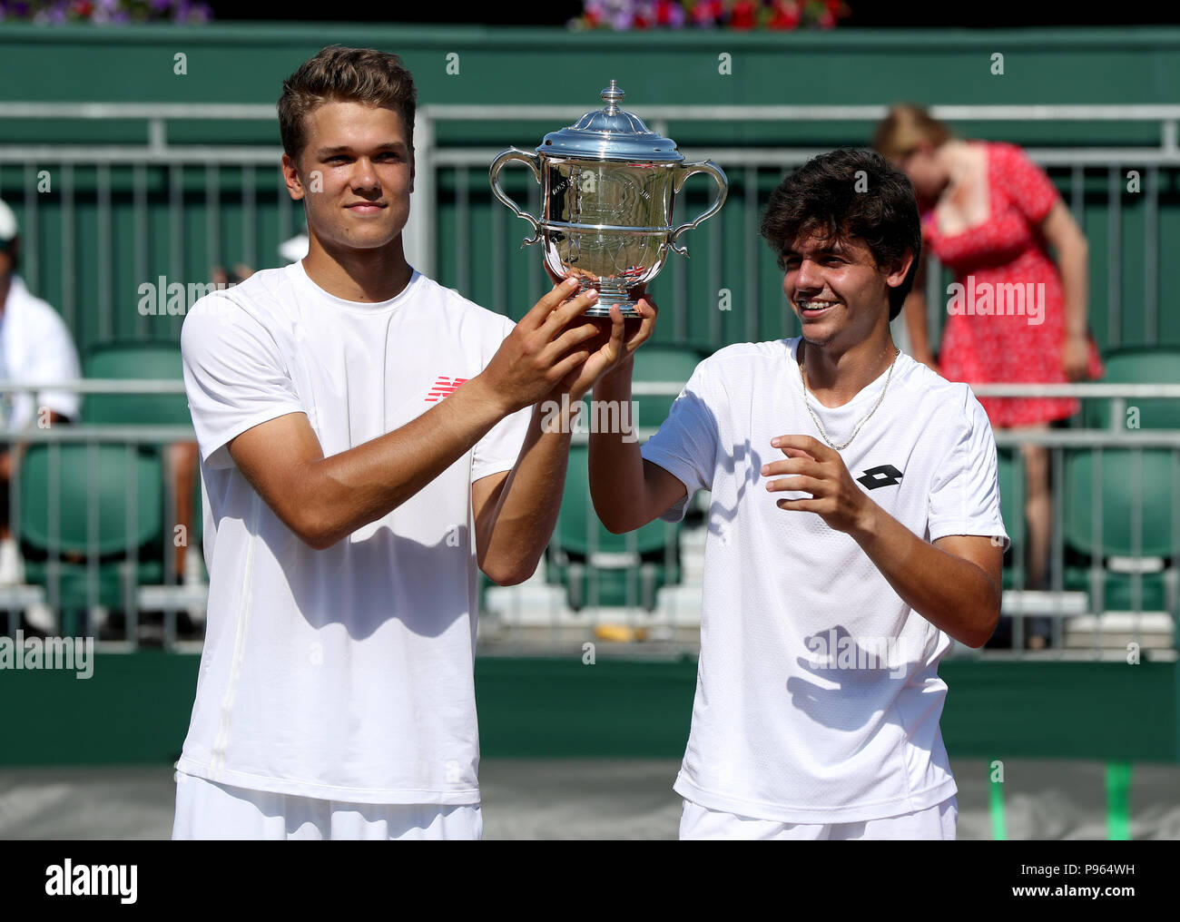 Yanki Erel (right) and Otto Virtanen with the trophy after winning the Boys Doubles on day thirteen of the Wimbledon Championships at the All England Lawn Tennis and Croquet Club, Wimbledon. PRESS ASSOCIATION Photo. Picture date: Sunday July 15, 2018. See PA story TENNIS Wimbledon. Photo credit should read: Jonathan Brady/PA Wire. Stock Photo