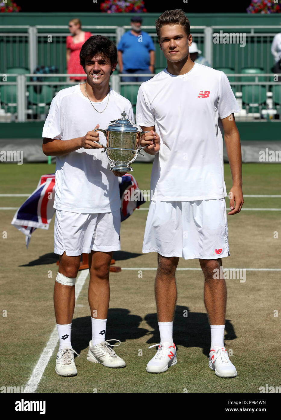 Yanki Erel (left) and Otto Virtanen with the trophy after winning the Boys Doubles on day thirteen of the Wimbledon Championships at the All England Lawn Tennis and Croquet Club, Wimbledon. PRESS ASSOCIATION Photo. Picture date: Sunday July 15, 2018. See PA story TENNIS Wimbledon. Photo credit should read: Jonathan Brady/PA Wire. Stock Photo