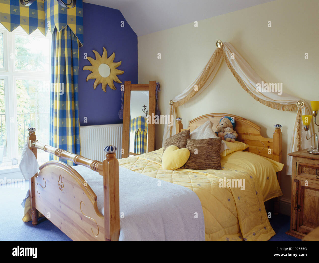 Blue+yellow checked curtains and pine bed with yellow bedlinen in small