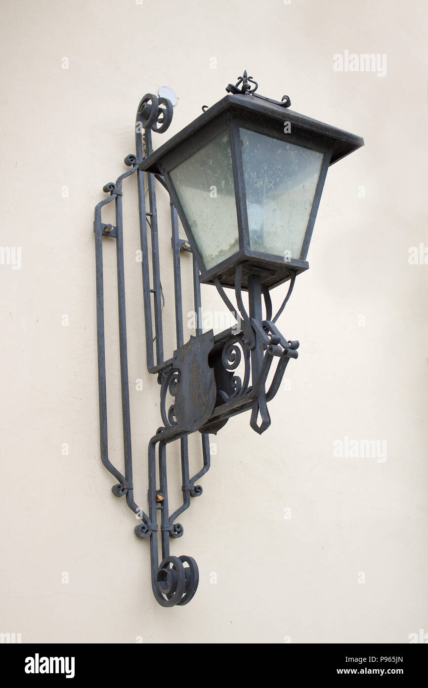 Photo of vintage Old Street Classic Iron Lantern On The House Wall, Close Up. Stock Photo