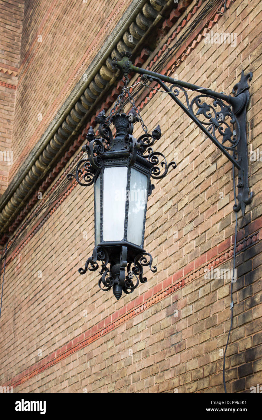Photo of vintage Old Street Classic Iron Lantern On The House Wall, Close Up. Stock Photo
