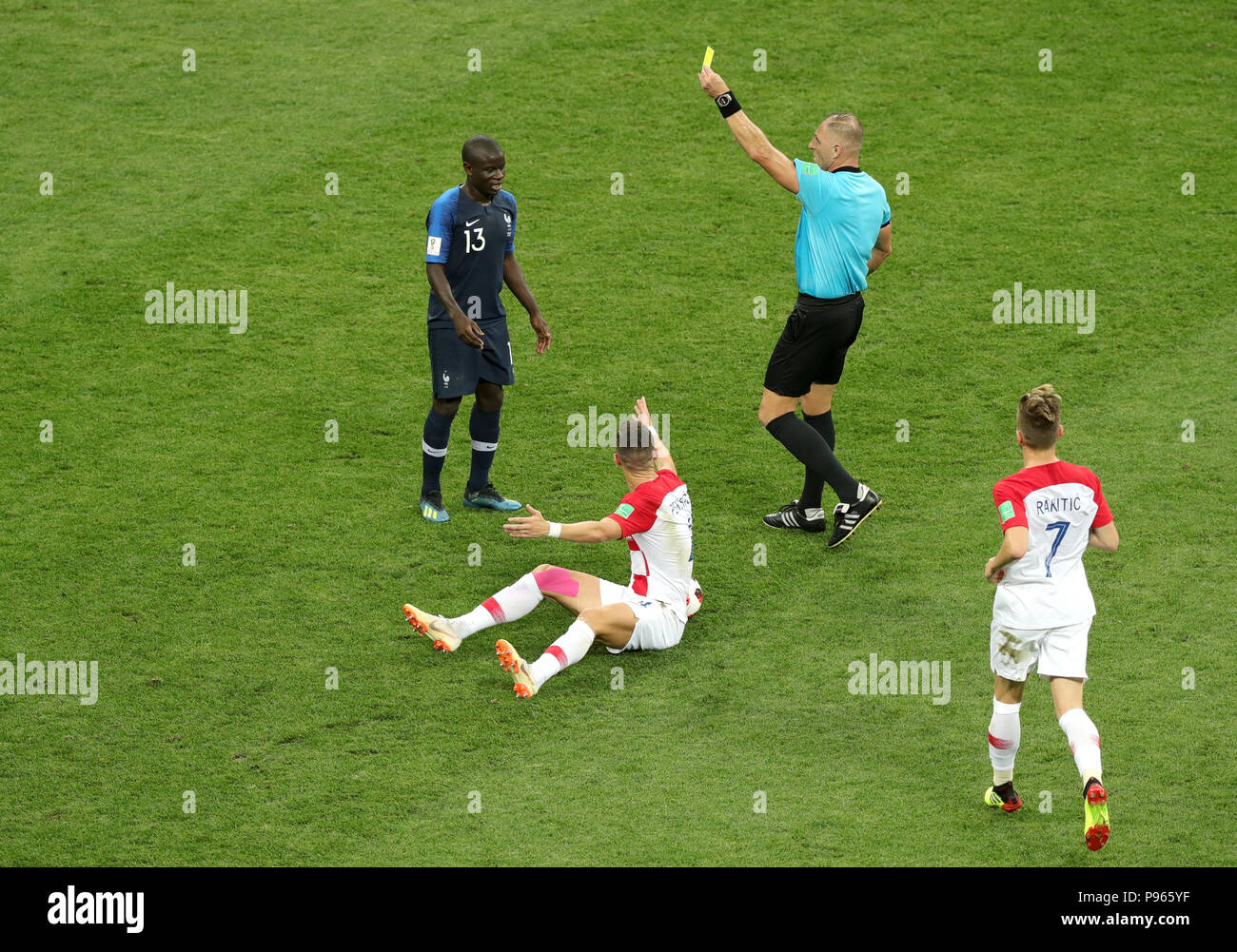France's N'Golo Kante (top left) is shown a yellow card by match referee Nestor Pitana during the FIFA World Cup Final at the Luzhniki Stadium, Moscow. Stock Photo