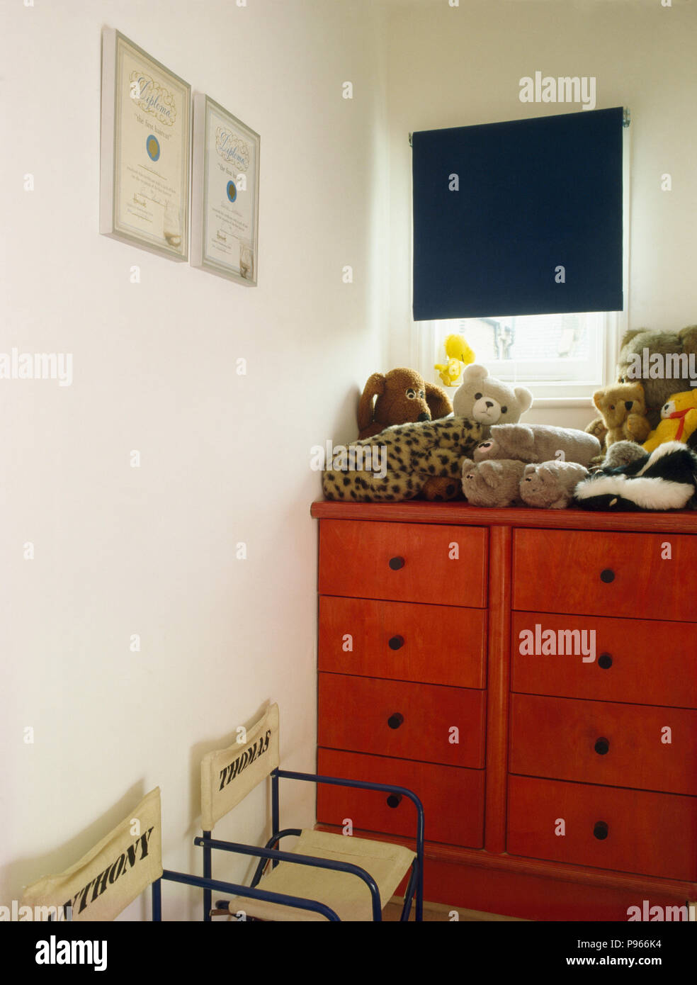 Soft Toys On Red Chest Of Drawers In Child S Bedroom Stock Photo