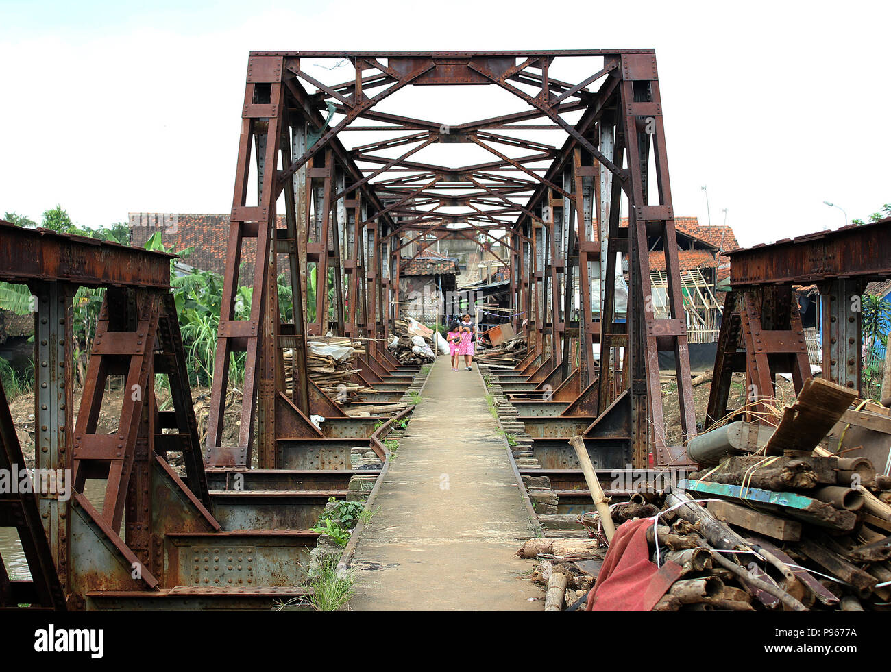 People crossed the unused railway bridge in Baleendah, Bandung ...