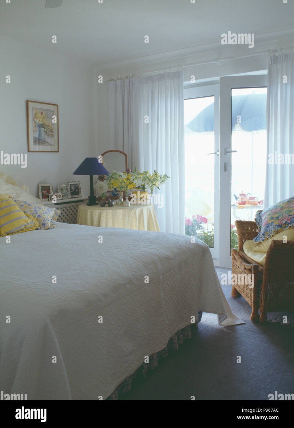 Seaside Bedroom With White Quilt On Bed And White Curtains