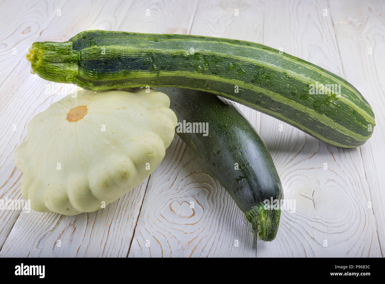 Patisson and zucchini on a wooden table. Stock Photo
