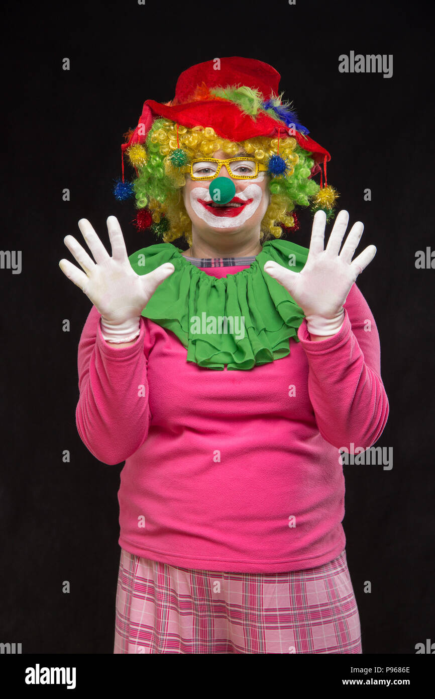 Funny curly clown in shiny glasses with good cheerful emotions Stock Photo