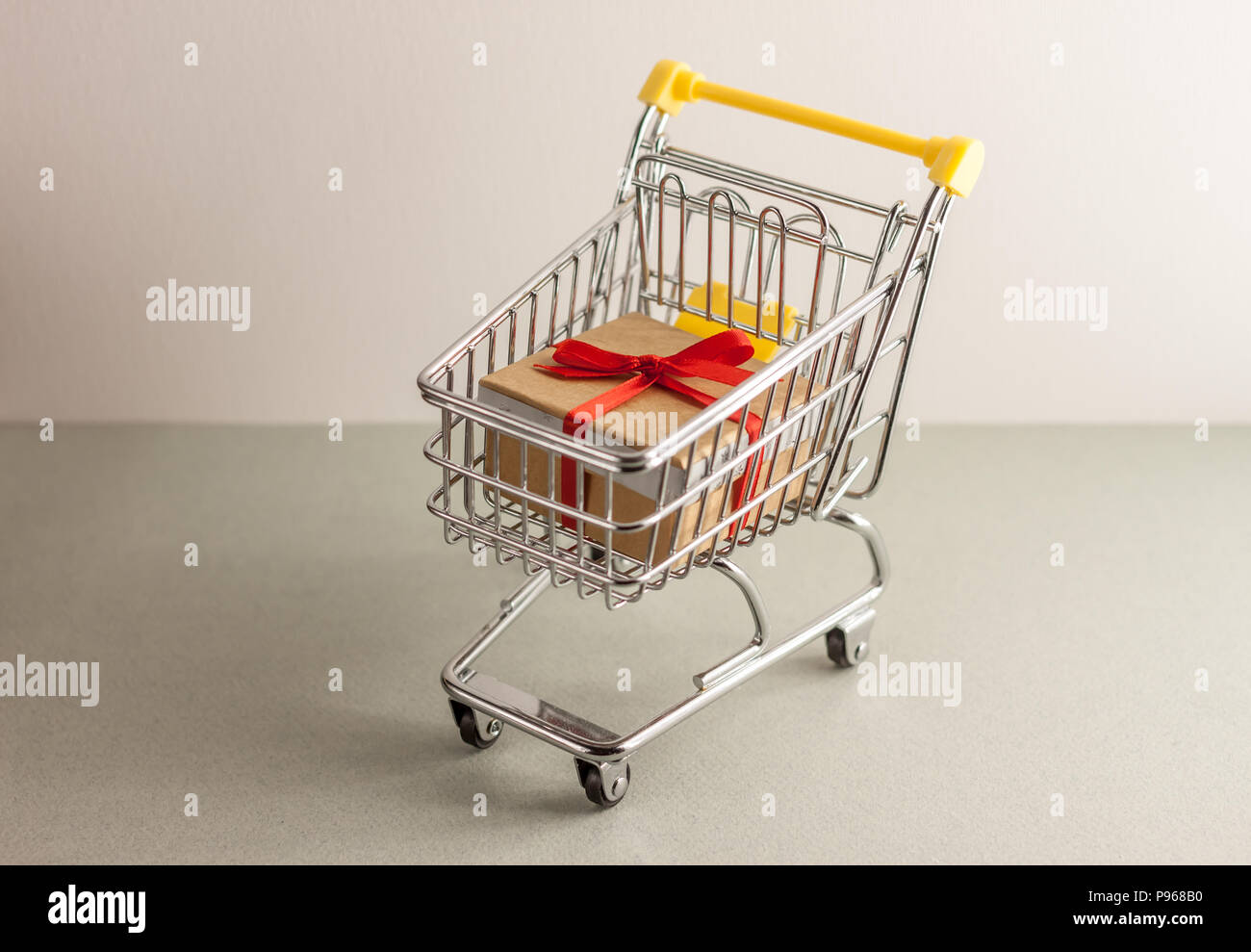 mini shopping cart with boxes with presents Stock Photo Alamy