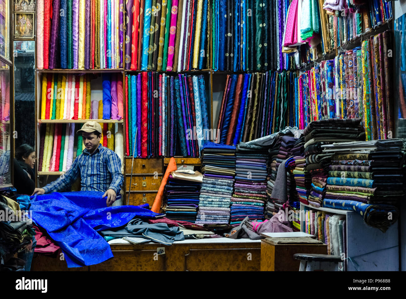 Nepali shop selling fabrics and textiles in Thamel, Kathmandu Stock Photo