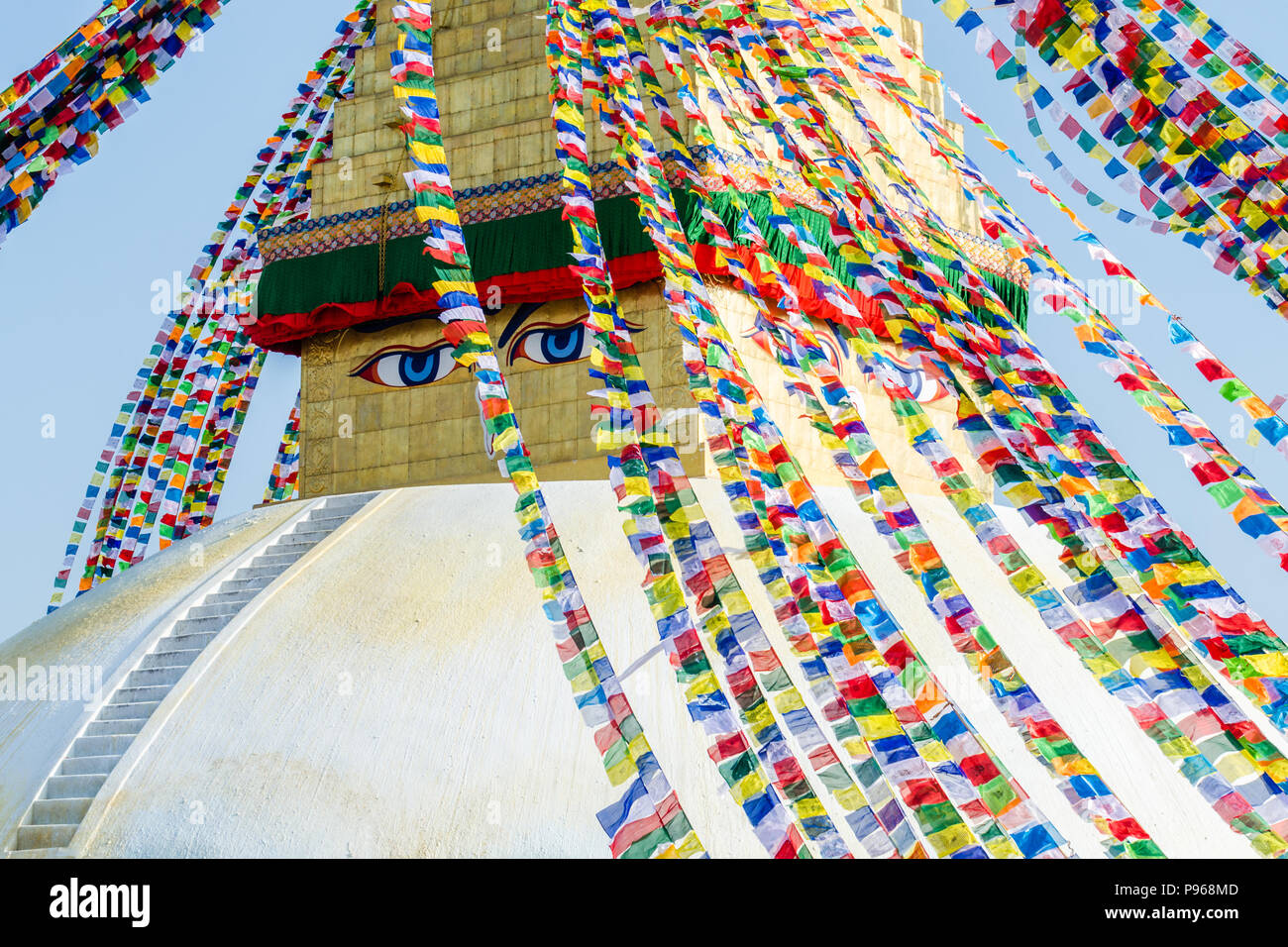 Close-Up shot of Buddha eyes, white stupa and the praying flags in Boudhanath or Buddha Stupa Stock Photo