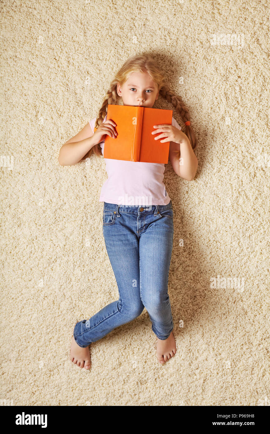school age girl with a book Stock Photo