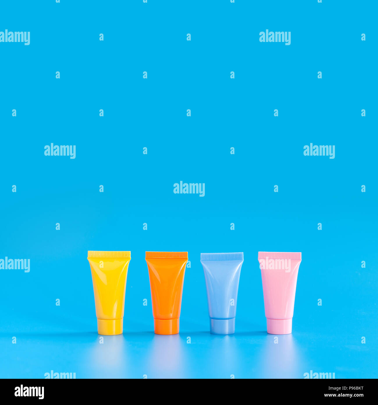 Download Cosmetic Tubes On Blue Background Yellow Orange Blue Pink Color Abstract Plastic Containers Hygiene Products Packaging Design Poster Template Copy Space Photography Stock Photo Alamy PSD Mockup Templates