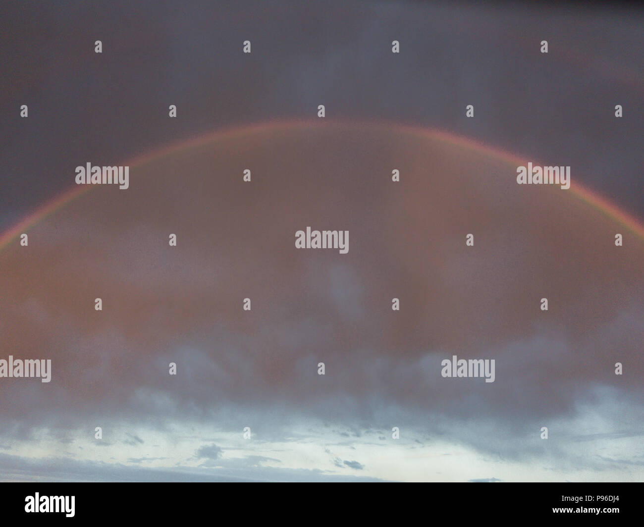 storm clouds after strong rain with Rainbow Stock Photo