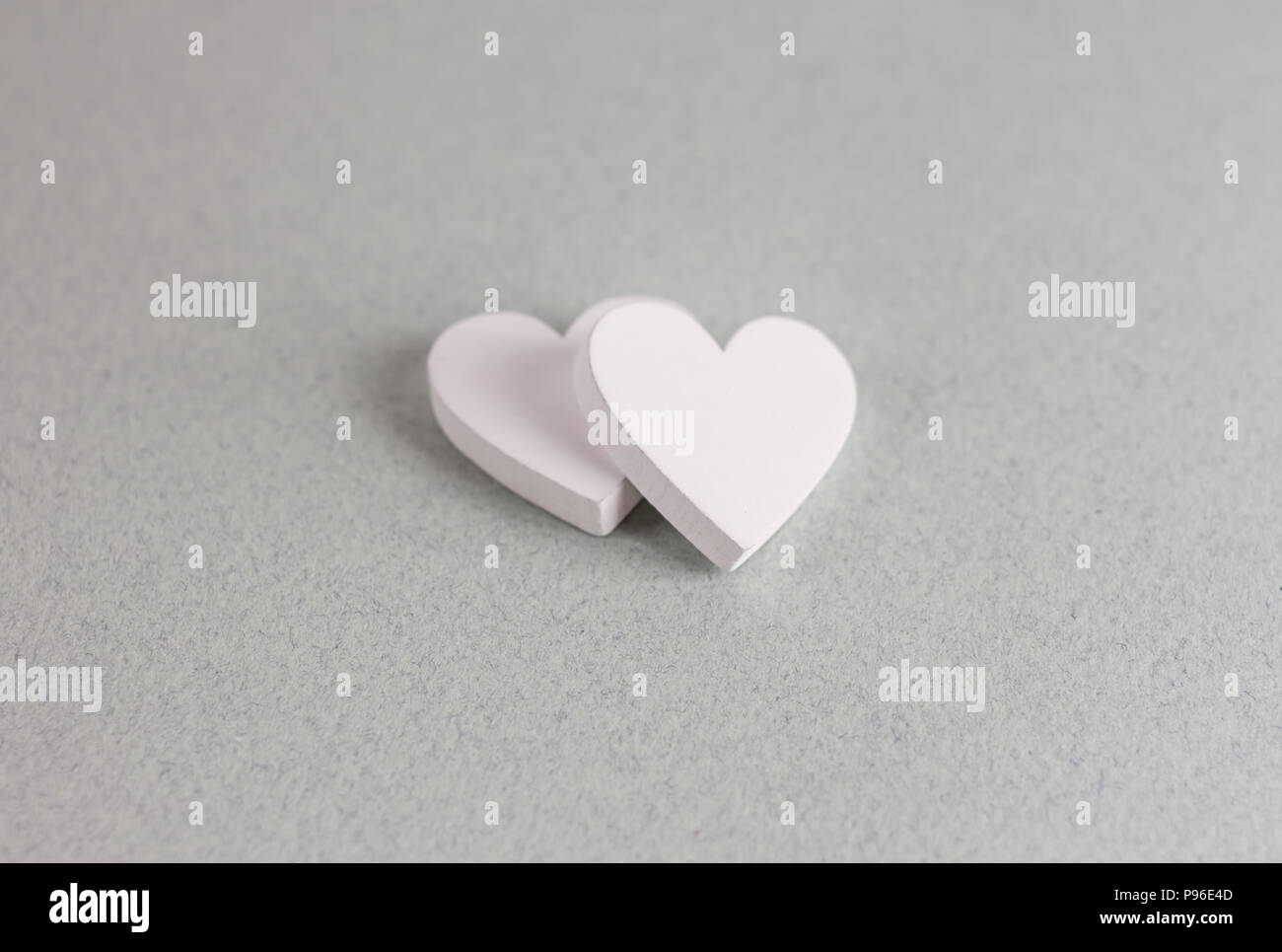 two wooden hearts on craft background Stock Photo