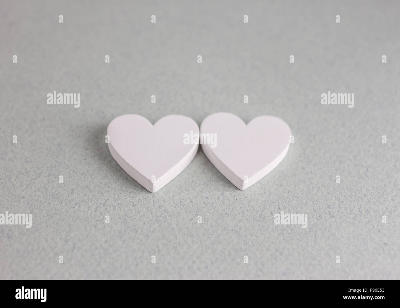 two wooden hearts on craft background Stock Photo