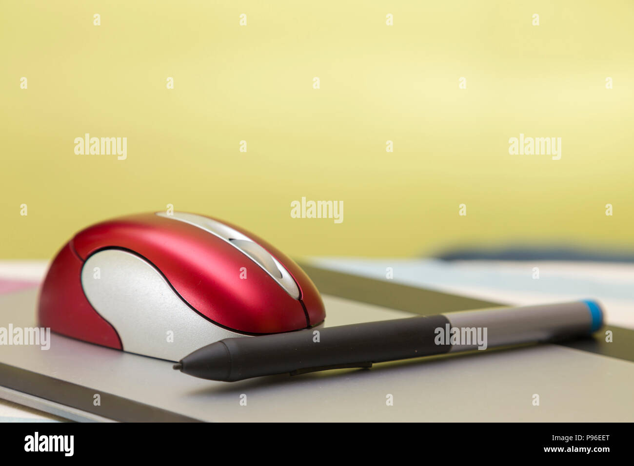 red wireless mouse and pencil, on a graphic tablet, computer peripherals Stock Photo