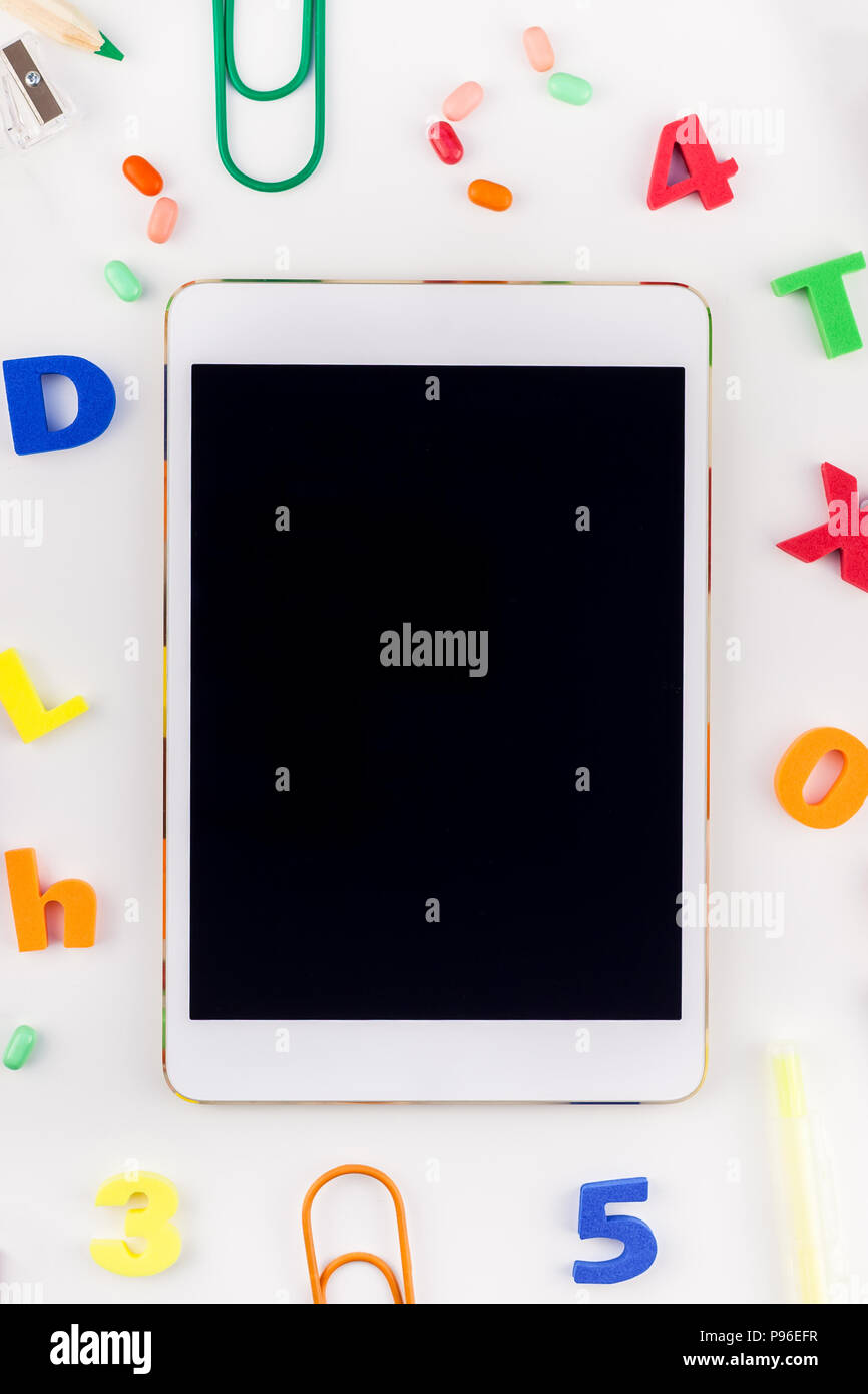 Creative flat lay back to school concept blank tablet with alarm clock ...