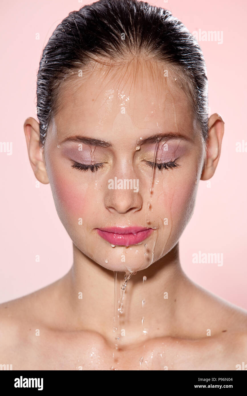 Beautiful Model Girl with splashes of water on her face. Beautiful