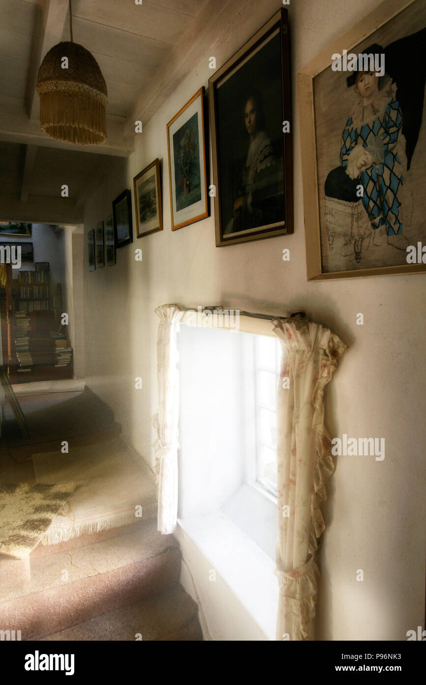 Cluttered , untidy but atmospheric rooms in old farm house full of character. Stock Photo