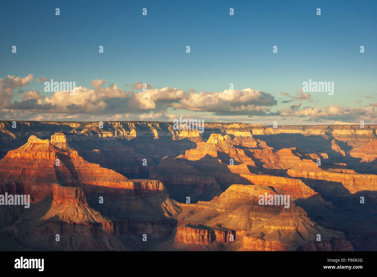 Sunlight at Grand Canyon seen from Mohave Point before sunset with some clouds in the sky Stock Photo