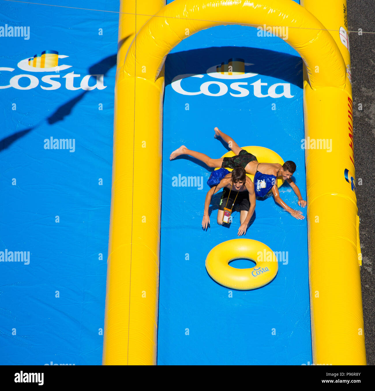 GENOA (GENOVA), ITALY, JULY, 7, 2018 - Two young boys playing in the longest water slide entered in the Guinness Book of Records showed for the Costa  Stock Photo