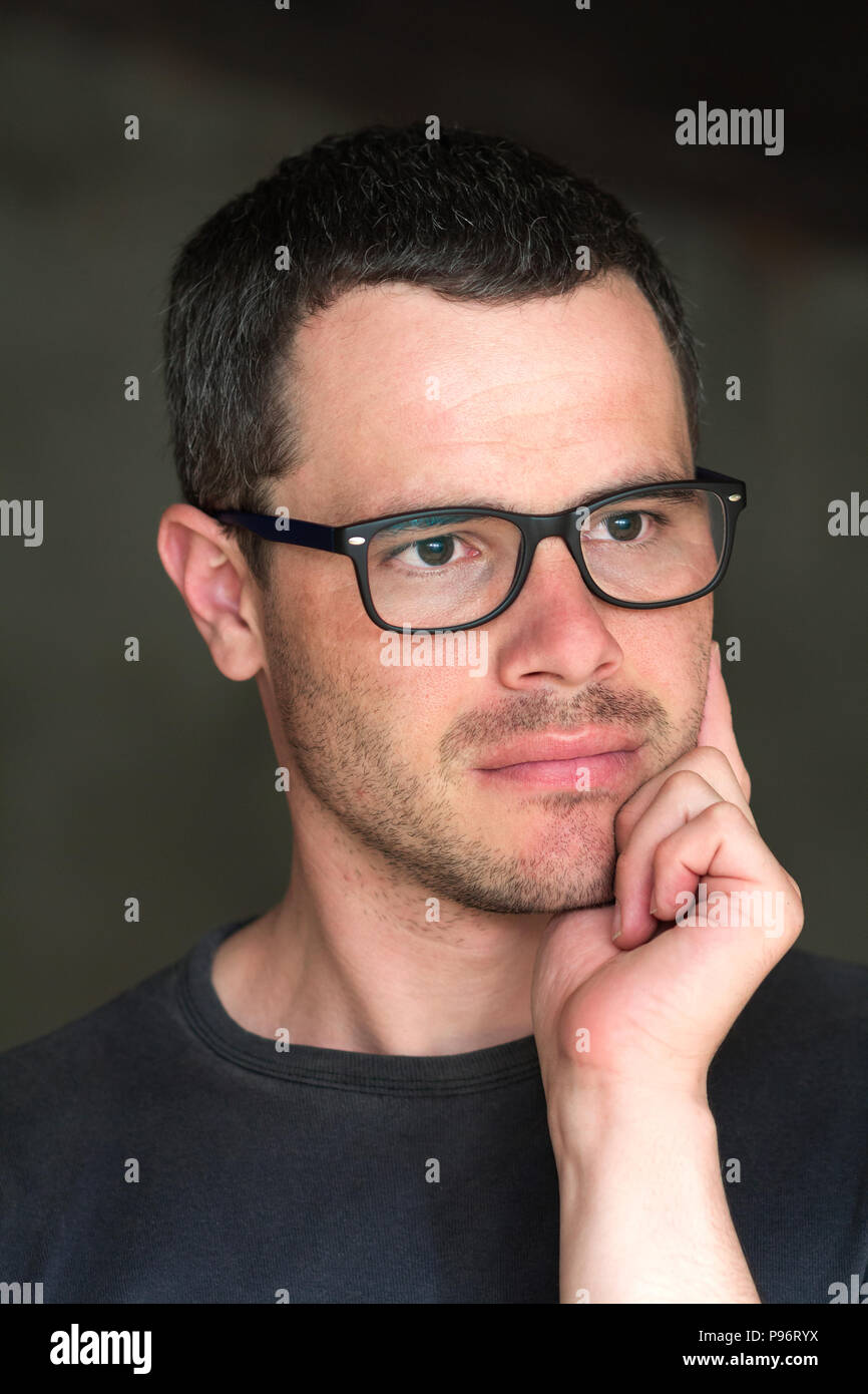 Intellectual Hand Some Portrait of young handsome serious black-haired unshaven confident ...