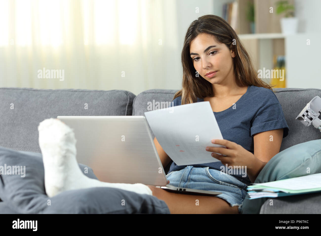 Disabled self employed working sitting on a couch in the living room at home Stock Photo