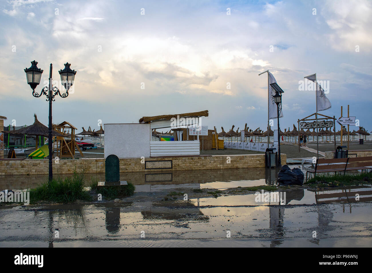 13 July 2018-Mamaia, Romania. The buidlings and terraces after a storm at the sea side with streets flooded at sunset. Stock Photo