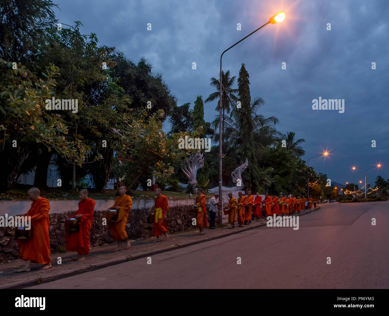 Alms Giving Ceremony in front of the Vat Phramahathat Rajbovoravihane temple, Luang Prabang, Laos Stock Photo