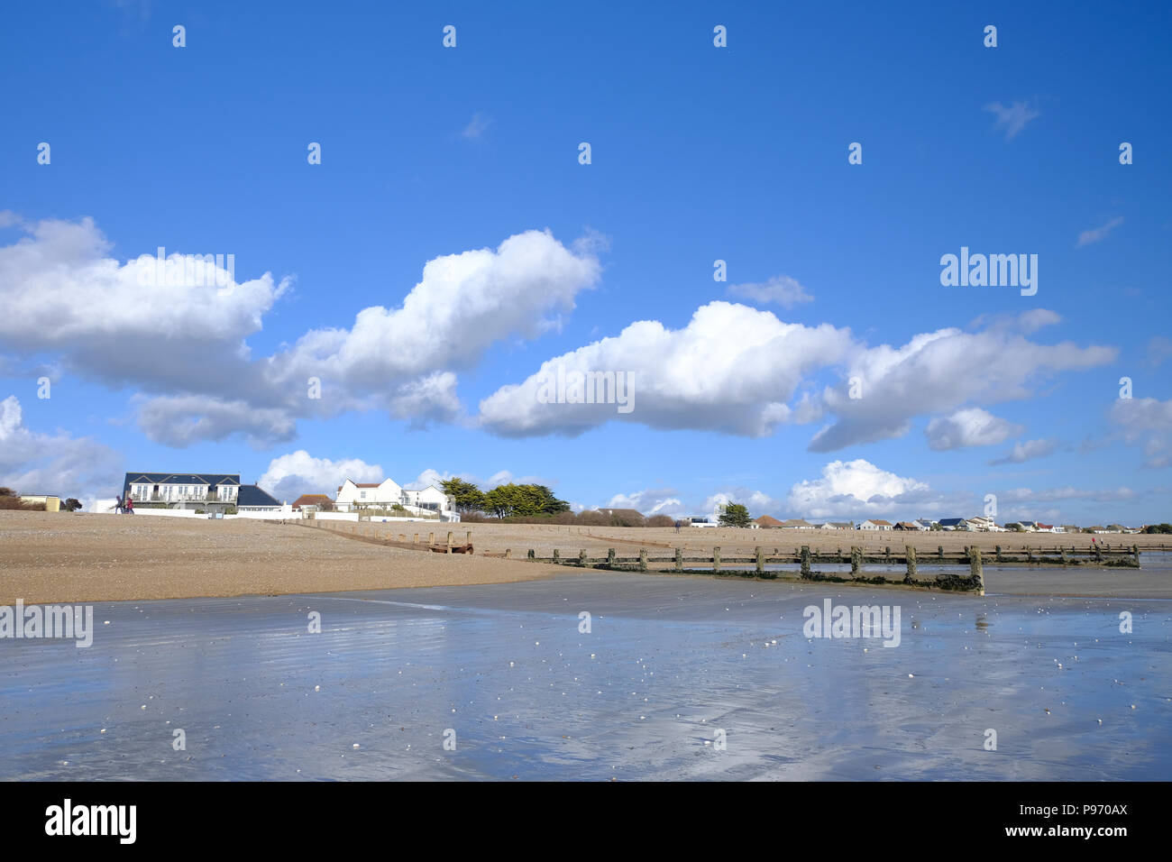 East Preston, UK. View of the beach at low tide in winterblue skies Stock Photo